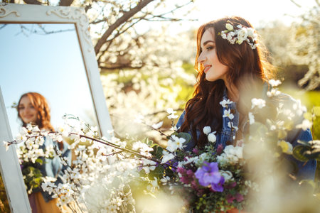 Portrait of a beautiful bride through mirror. wedding concept. Stylish wedding. Great sunset light.の写真素材