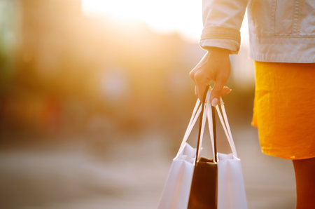 Shopping bags in the woman hands. Sale, shopping, tourism and happy people concept.の写真素材