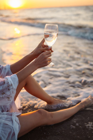 Stylish woman in elegant white dress posing near the sea. People, freedom, lifestyle, travel.の写真素材