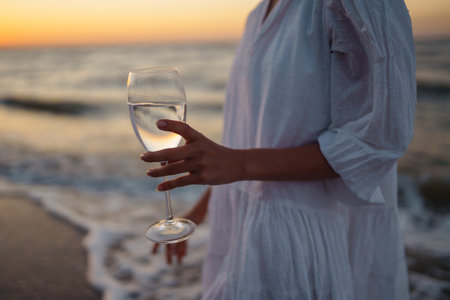 Stylish woman in elegant white dress posing near the sea. summertime. Travel, weekend, relax.の写真素材