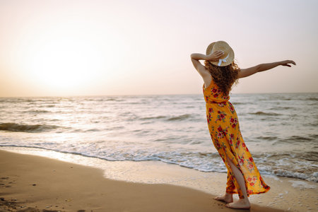 Stylish woman in elegant dress posing near the sea. summertime. Travel, weekend, relax.の写真素材