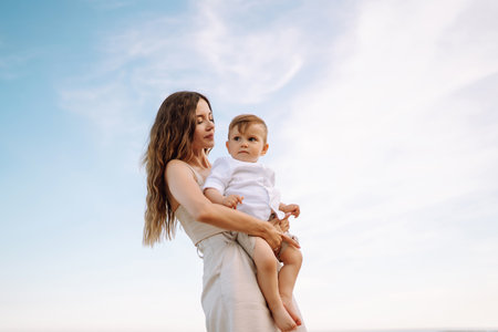 Beautiful mother and child resting on the beach. active lifestyle. happy childhood.の写真素材