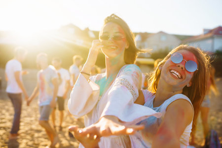 Two beautiful girls have a great time on Holi festival. Spring Break Beach Party. Friendship, Leisure, Vacationの写真素材