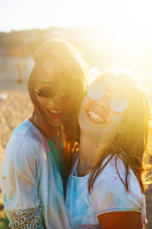 Two beautiful girls have a great time on Holi festival. Spring Break Beach Party. Friendship, Leisure, Vacationの写真素材