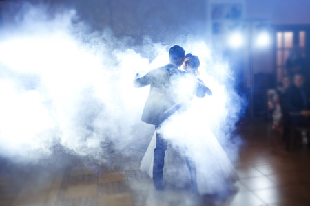 First wedding dance of newlywed. Wedding couple dancing in the darkness. . Happy bride and groom.の写真素材