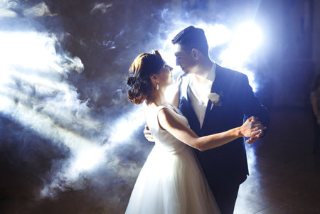 First wedding dance of newlywed. Wedding couple dancing in the darkness. . Happy bride and groom.