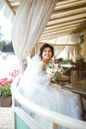 Beautiful bride with wedding flowers bouquet, attractive woman in wedding dress. happy newlywed woman.の写真素材