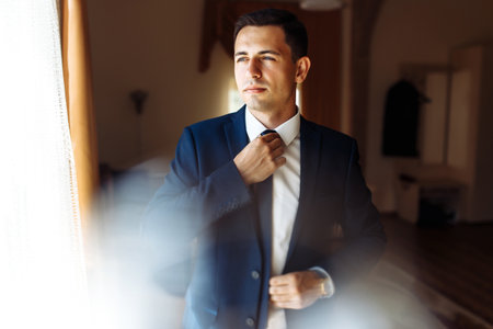 Stylish groomsmen. businessman. Luxury man in suit room. Groom morning preparation. wedding day.の写真素材