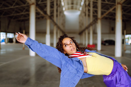 Beautiful sportive girl dancing in stylish clothes in the underpass. Sport,dancing and urban cultureの写真素材
