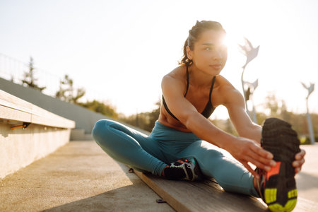 Fit Young woman in sportswear doing yoga, fitness exercise on the street. Sport, Active life.の写真素材