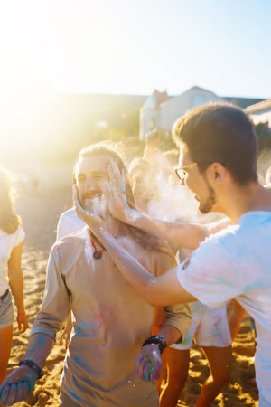 Teenagers Friends have fun at the holi festival. beach party. Celebrating traditional Indian spring...