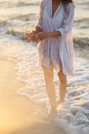 Stylish woman in elegant white dress posing near the sea. People, freedom, lifestyle, travel.の写真素材