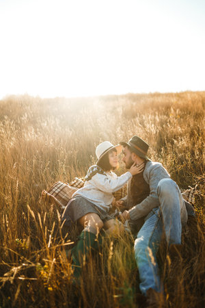 Lovely hipster couple with cat. Couple wearing beautiful hats and sweaters. lifestyle.の写真素材