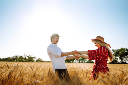 Loving couple having fun and enjoying relaxation in a wheat field.の写真素材