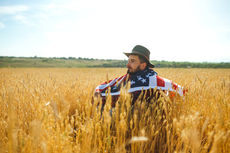 4th of July. American Flag. Patriotic holiday. Traveler with the flag of America. beautiful sunset light. american style.の写真素材