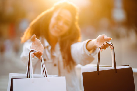 Young woman with shopping bags walking on the street. , sale concept.の写真素材