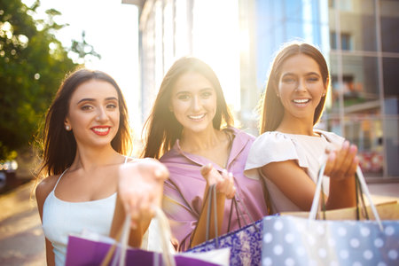 Beautiful girl with packages after shopping A picture of a group of happy friends shopping in the city.の写真素材