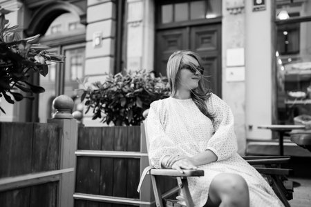 Young Woman chilling in cozy cafe, looking around, happy emotions. Traveling woman.の写真素材