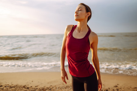 Young woman in sportswear doing yoga, fitness exercise on the beach. Sport, Active life.の写真素材