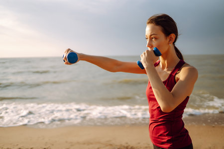 Young woman doing exercises outdoors in the morning. Active life, sports training, fitness, yoga.の写真素材