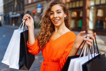 shopping woman. Young woman with shopping bags in the city. Vacation, sale or purchase concept.の写真素材