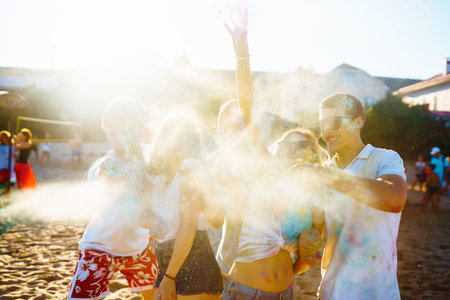 A group of friends have fun, dance at the holi festival. Spring Beach Party. Friendship, Leisure, Togetherness.の写真素材