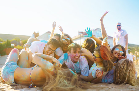 A group of friends have fun, dance at the holi festival. Celebrating traditional Indian spring...