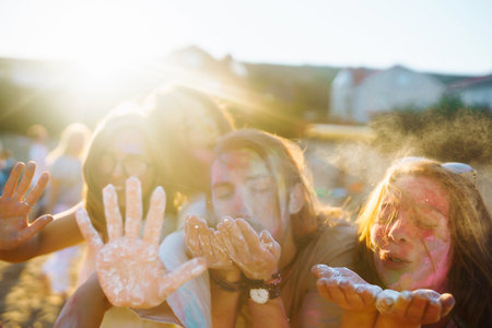 A group of friends have fun, dance at the holi festival. Spring Beach Party. Friendship, Leisure, Togetherness.の写真素材