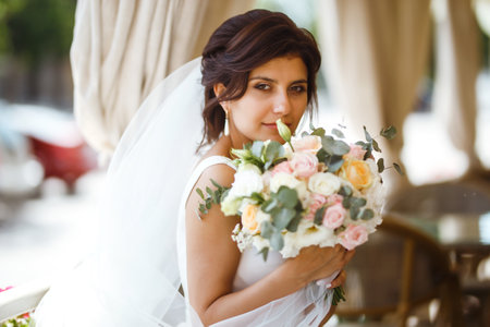 Beautiful bride with wedding flowers bouquet, attractive woman in wedding dress. happy newlywed woman.の写真素材