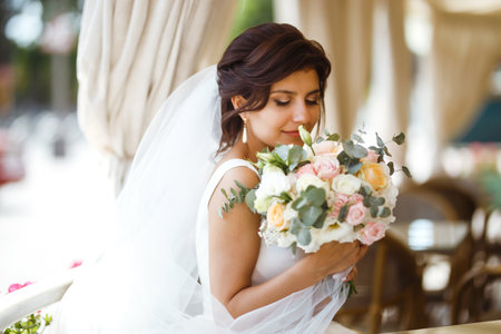 Beautiful bride with wedding flowers bouquet, attractive woman in wedding dress. happy newlywed woman.の写真素材