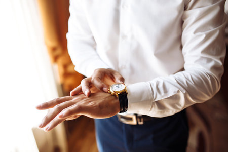 Stylish men's wrist watch, the man is watching the time. . Businessman checking time on his...