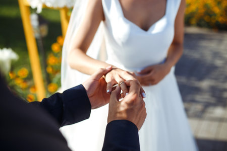 wedding engagement rings. Newlywed couple's hands with engagement rings. Young couple at ceremony.の写真素材
