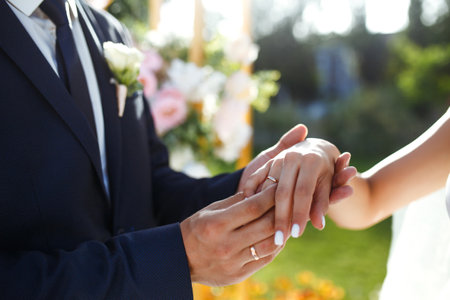 wedding engagement rings. Newlywed couple's hands with engagement rings. Young couple at ceremony.の写真素材