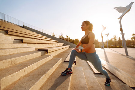 Fit Young woman in sportswear doing yoga, fitness exercise on the street. Sport, Active life.の写真素材