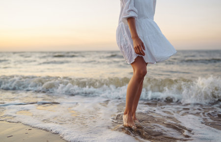 Stylish woman in elegant white dress posing near the sea. summertime. Travel, weekend, relax.の写真素材