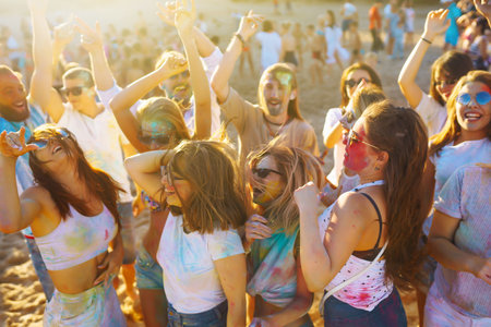 Teenagers Friends have fun at the holi festival. beach party. Celebrating traditional Indian spring holiday.の写真素材