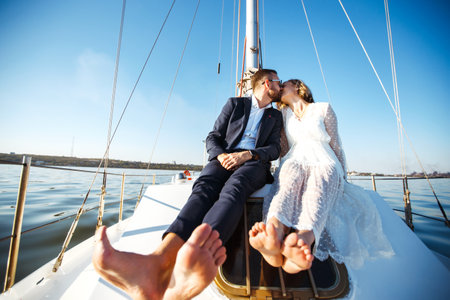 Beautiful wedding couple on yacht at wedding day outdoors in the sea. Together. wedding day.の写真素材