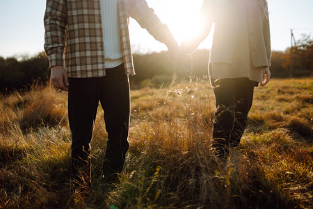Happy couple in love walking in park on a autumn day. Relaxation, youth, love, lifestyle concept.の写真素材