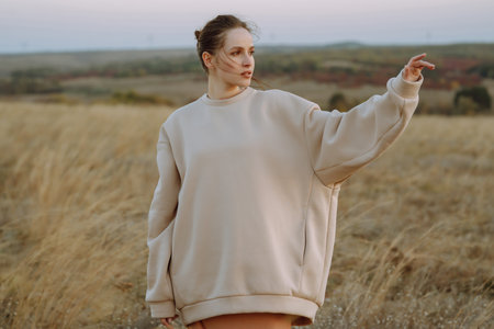 Beautiful model in stylish clothes posing on autumn field. fashion concept. Lifestyle, recreation.の写真素材