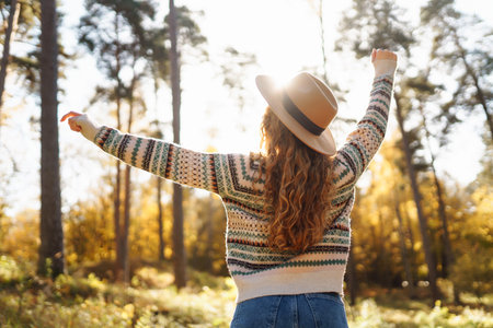 outdoor atmospheric lifestyle. portrait of beautiful woman having fun in autumn forest. warm autumnの写真素材