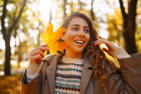 outdoor atmospheric lifestyle. portrait of beautiful woman having fun in autumn forest. warm autumn