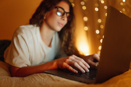 Working on laptop. Young woman studying sitting at home. Business, freelance, education concept.の写真素材