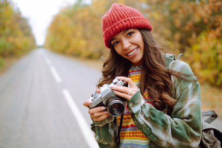 Beautiful young woman is photographed with a retro camera. Rest, relaxation, travel, lifestyle...