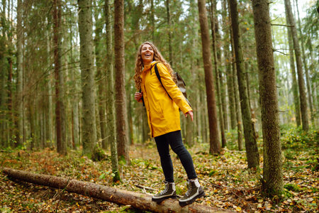 Happy woman enjoying green beautiful nature woods forest. Concept of healthy natural lifestyle.の写真素材