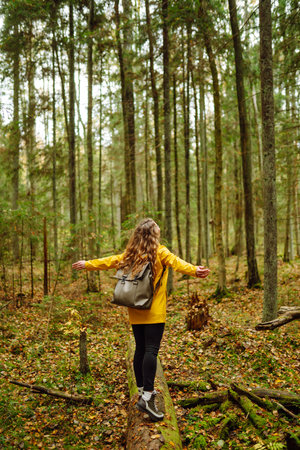 Happy woman enjoying green beautiful nature woods forest. Concept of healthy natural lifestyle.