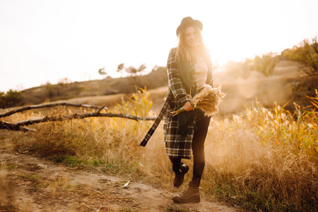 Stylish woman enjoying autumn weather in the park. Fashion, style concept. People, lifestyle.の写真素材