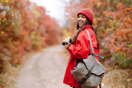 Smiling woman enjoying autumn weather. Rest, relaxation, lifestyle concept.