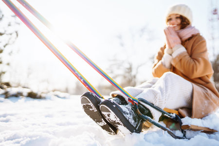 Young woman rolls on a sled in the winter snowy forest. Nature, holidays, rest, travel concept.