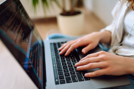 Close-up of woman's hands on a laptop keyboard, typing on modern laptop at home. Freelancing concept