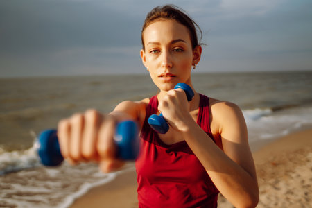 Young woman doing exercises outdoors in the morning. Active life, sports training, fitness, yoga.の写真素材